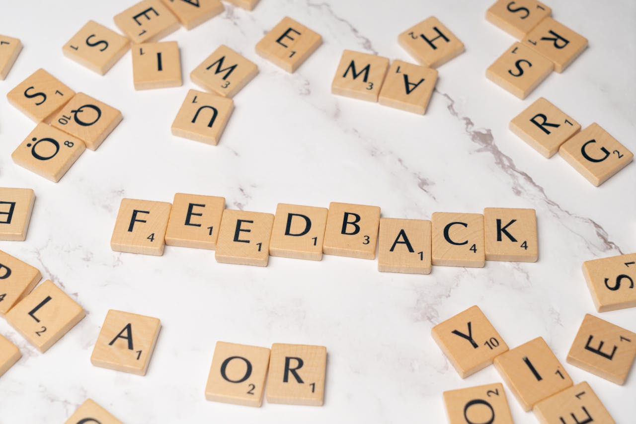 Mastering the First Impression: Your intriguing post title goes here Wooden Scrabble tiles arranged to spell 'Feedback' on a marble background.